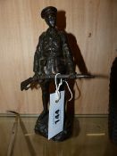 A BRONZE FIGURE OF A WWI SOLDIER CARRYING HIS RIFLE, SIGNED TO BASE GOMERT. H.22cms.