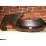 AN UNUSUAL ANTIQUE CARVED AND POLYCHROME LARGE TREEN BOWL WITH SCROLL HANDLE. L.72cms.