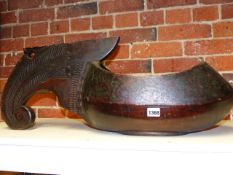 AN UNUSUAL ANTIQUE CARVED AND POLYCHROME LARGE TREEN BOWL WITH SCROLL HANDLE. L.72cms.