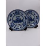 A PAIR OF ANTIQUE DELFT BLUE AND WHITE PLATES WITH ORIENTAL LANDSCAPE DECORATION. D.20cms.