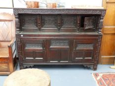 A 17th.C.AND LATER OAK COURT CUPBOARD WITH CARVED PANEL DOORS AND FRIEZE. W.182 x H.140cms. APPROX.