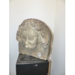 A PAIR OF CARVED STONE DEEP RELIEF MASKS DEPICTING A LONG HAIRED MOUSTACHED GENTLEMAN. APPROX.H.
