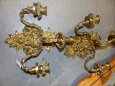 A PAIR OF ORMOLU REGENCE STYLE FRENCH THREE LIGHT WALL APPLIQUES, SCROLLED FOLIATE BRANCHES ISSUE