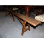 A PAIR OF ANTIQUE ELM FORMS OR BENCHES ON SPLAYED MORTISED LEGS. L.213cms.