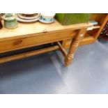 A LARGE PINE REFECTORY STYLE DINING TABLE.
