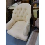 AN EARLY VICTORIAN BUTTON BACK ARMCHAIR.