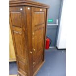 AN OAK ENCLOSED GUN CABINET.