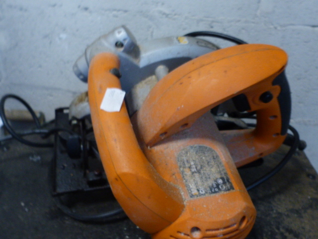 A ROBIN PETROL STRIMMER AND A CIRCULAR SAW.