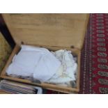 A VICTORIAN PINE BLANKET BOX AND QTY OF LINENS.