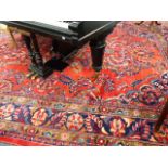 A LARGE HAND WOVEN PERSIAN PATTERN RED GROUND CARPET.