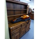 A GOOD QUALITY CARVED OAK DRESSER AND PLATE RACK.