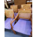 A SET OF FOUR TEAK ARMCHAIRS.