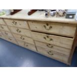 AN IMPRESSIVE LARGE PINE SIXTEEN DRAWER SIDE UNIT.