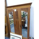 AN EDWARDIAN WALNUT MIRROR DOOR WARDROBE.