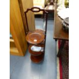 AN EDWARDIAN MAHOGANY FOLDING CAKESTAND.