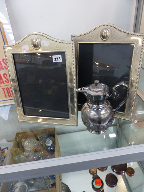 A PAIR OF PLATED FRAMES AND A HOT WATER JUG.