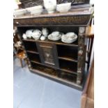 A VICTORIAN CARVED OAK BOOKCASE.