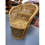 A RATTAN CHAIR.