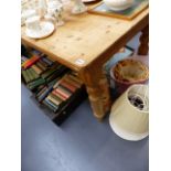 A LARGE PINE KITCHEN TABLE ON TURNED LEGS.