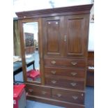 A LARGE EDWARDIAN MAHOGANY COMPACTUM WARDROBE BY SHULBRED & CO.