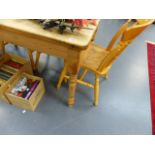 A SMALL PINE KITCHEN TABLE AND THREE CHAIRS.