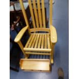 A ROCKING CHAIR AND A WALL SHELF.