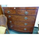 A REGENCY MAHOGANY AND INLAID BOW FRONT CHEST OF DRAWERS.