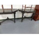 A PAIR OF EBONISED CONSOLE TABLES.