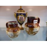 TWO DOULTON STONEWARE JUGS WITH SILVER MOUNTS AND A COALPORT JUBILEE VASE AND COVER.