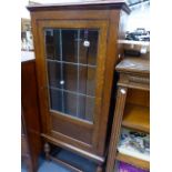 AN OAK GLAZED CABINET.