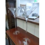 A PAIR OF TALL GLASS VASES.