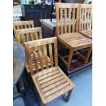A SET OF SIX TEAK DINING CHAIRS.
