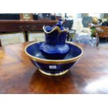 A BLUE AND GILT WASH JUG AND BASIN.