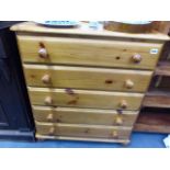 A HARDWOOD SMALL BOOKCASE AND A SMALL PINE CHEST OF DRAWERS.