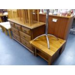 A GLASS TOPPED TABLE AND A COFFEE TABLE TOGETHER WITH A MODERN CHEST OF DRAWERS.