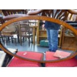 A MAHOGANY AND SATINWOOD OVAL MIRROR.