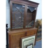 A GLAZED BOOKCASE CABINET AND AN ENCLOSED CABINET.