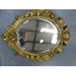 AN ANTIQUE BRASS FRAMED MIRROR