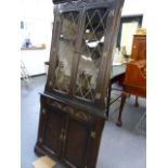 AN OAK CORNER CABINET.