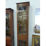 AN EDWARDIAN OAK TALL NARROW BOOKCASE.