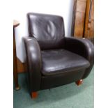 A LEATHER UPHOLSTERED ARMCHAIR.
