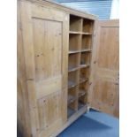 A LARGE VICTORIAN PINE CABINET WITH PIGEONHOLE INTERIOR.