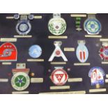 A COLLECTION OF MOTOR CAR BADGES.