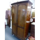 AN EDWARDIAN MAHOGANY BOW FRONT WARDROBE.