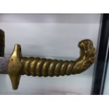 AN ANTIQUE BRASS HILTED DAGGER.