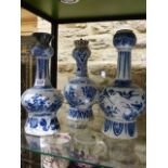 THREE EARLY DELFT POTTERY VASES WITH ELONGATED NECKS. H.34cms. (2) AND H.32cms.
