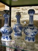 THREE EARLY DELFT POTTERY VASES WITH ELONGATED NECKS. H.34cms. (2) AND H.32cms.