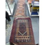 AN ANTIQUE PERSIAN HAMADAN RUNNER. 292 x 79cms AND A BELOUCH PRAYER RUG.