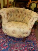 A 19th.C.BUTTON UPHOLSTERED TUB ARMCHAIR ON TURNED FORELEGS WITH BRASS CASTERS.