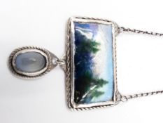 AN ARTS AND CRAFT STYLE ENAMELLED PENDANT. THE CENTRAL RECTANGLE ENAMEL IS A MOUNTAIN LANDSCAPE